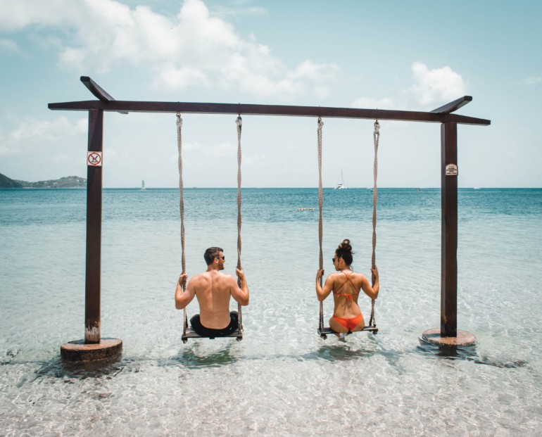 couple swinging in ocean