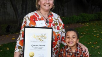 Mother and son accepting award from Community Action Marin
