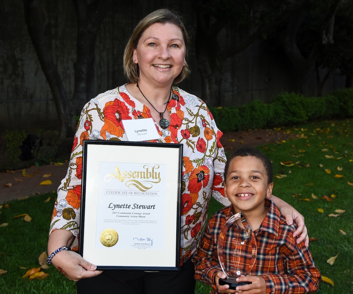 Mother and son accepting award from Community Action Marin