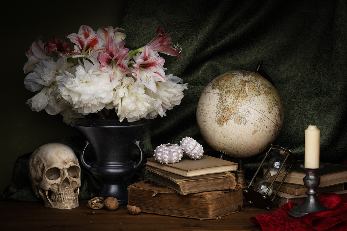 Photograph of flowers, a skull, a globe and books — by Anthony Delgado and titled "Memento Mori" for Marin Art and Garden Center's exhibit, Memento Mori Memento Vivere
