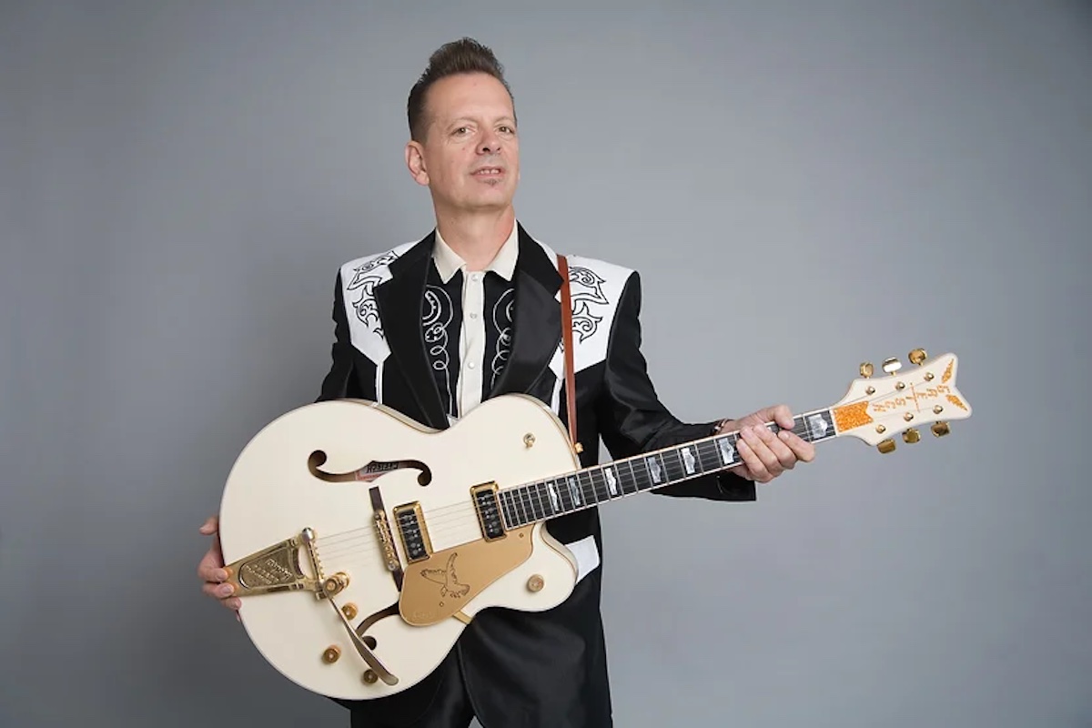 San Francisco-based Jinx Jones in classic country getup and holding big Gretsch guitar, playing live music in Marin this April 