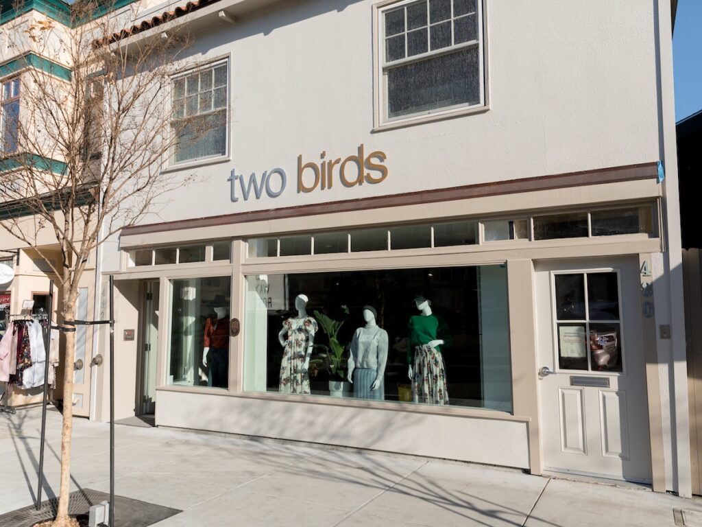 Facade of Two Birds store in Larkspur, with styled mannequins in the window