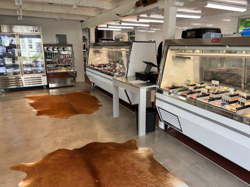 Meat counter with cowhide rugs in Zonda Fine Meats