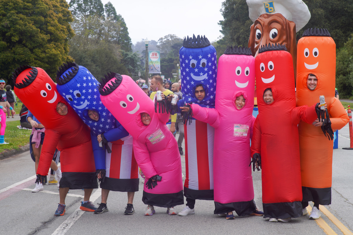 Friends in inflatable costumes smile at the Bay to Breakers race in San Francisco