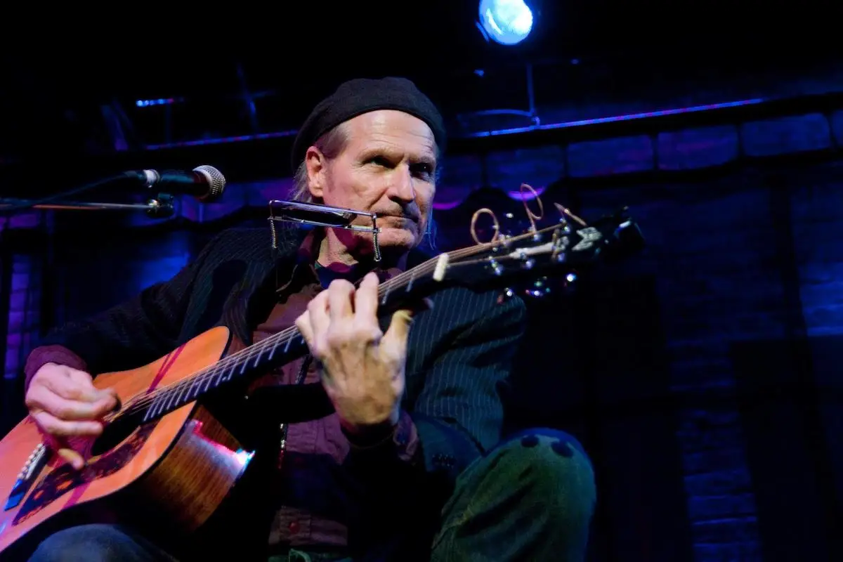 country musician Butch Hancock plays guitar on stage