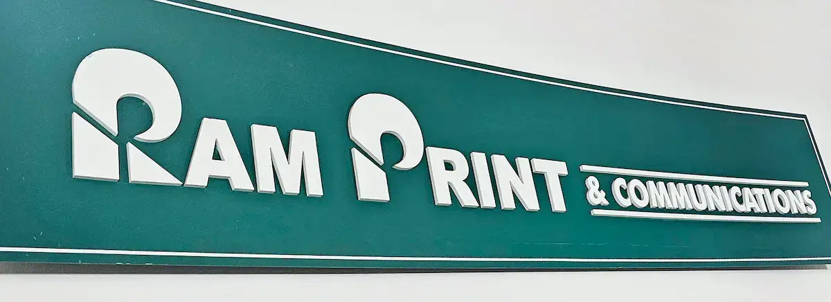 Green sign for the shop of Ram Print and Communications