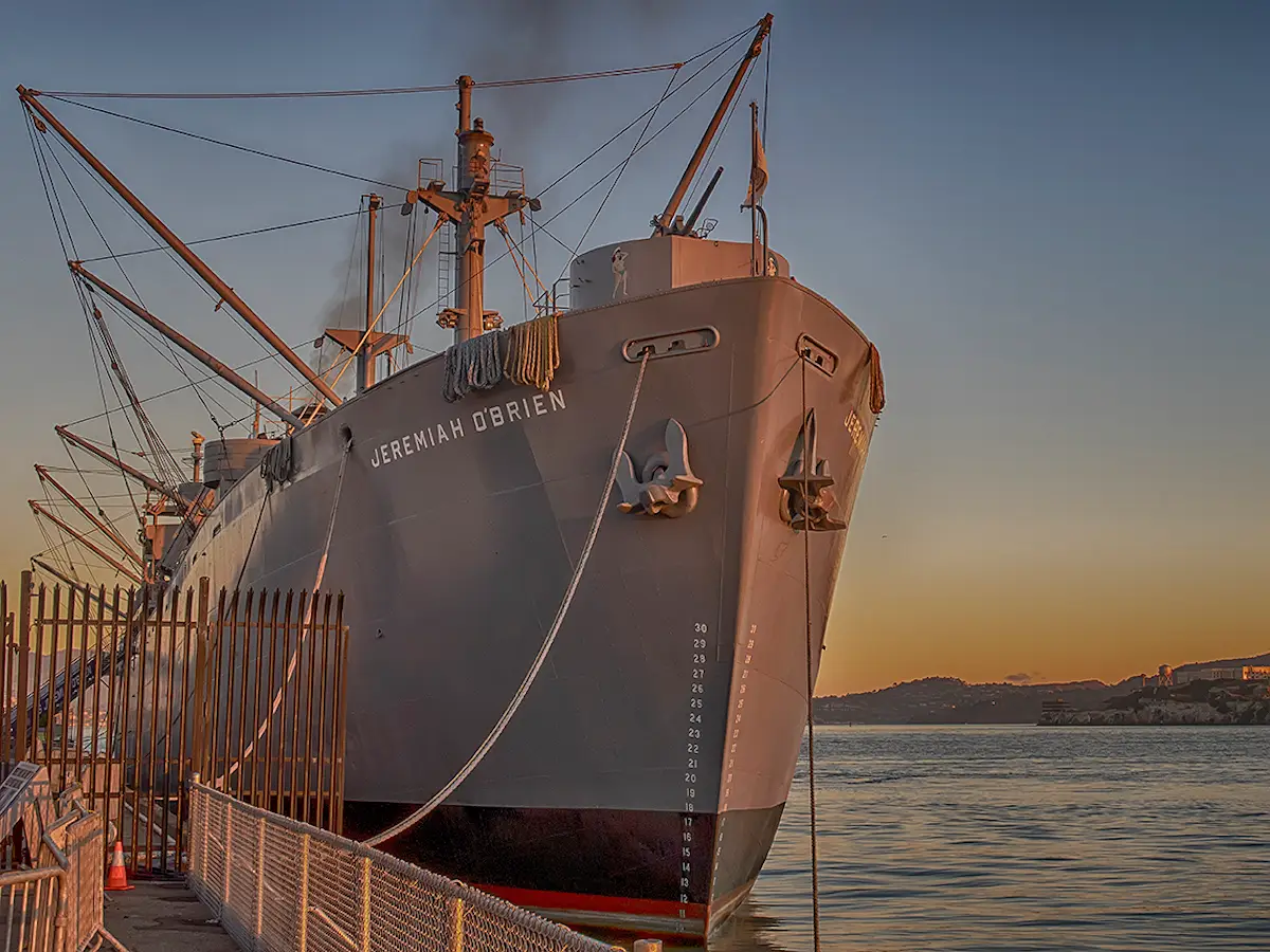 Front view of SS Jeremiah O'Brien on the bay at sunrise