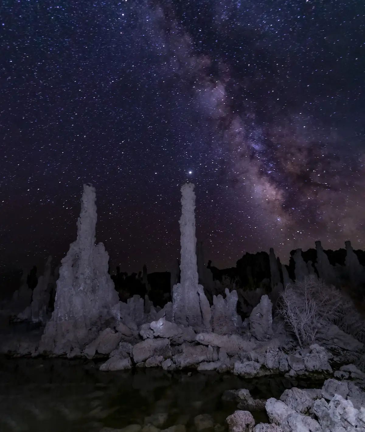 Tufas lit up by Milky Way and night sky in nature photo by Jay Tamang