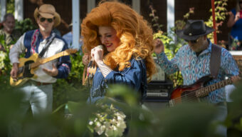 Singer wearing big wig at San Rafael PorchFest