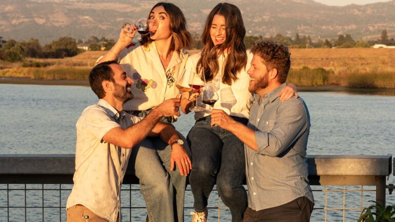 Friends drinking wine by the river at the River Club