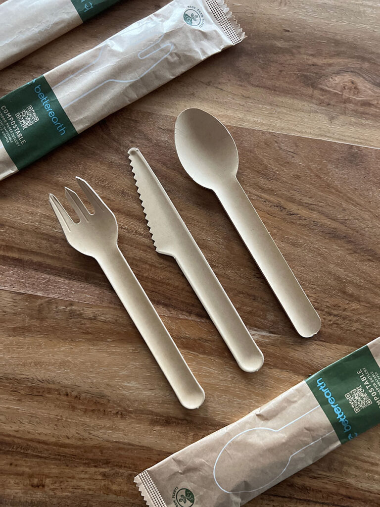 Compostable fork, knife, and spoon with paper packaging.