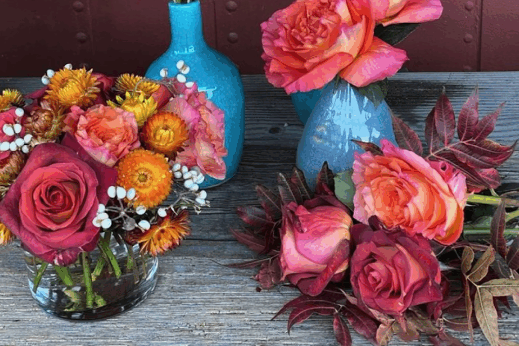 Vases with lots of colorful pink roses and baby's breath flowers.