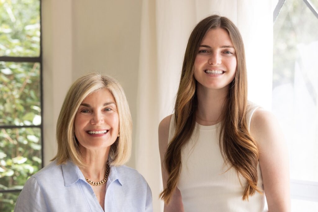 Two girls standing for a photo.