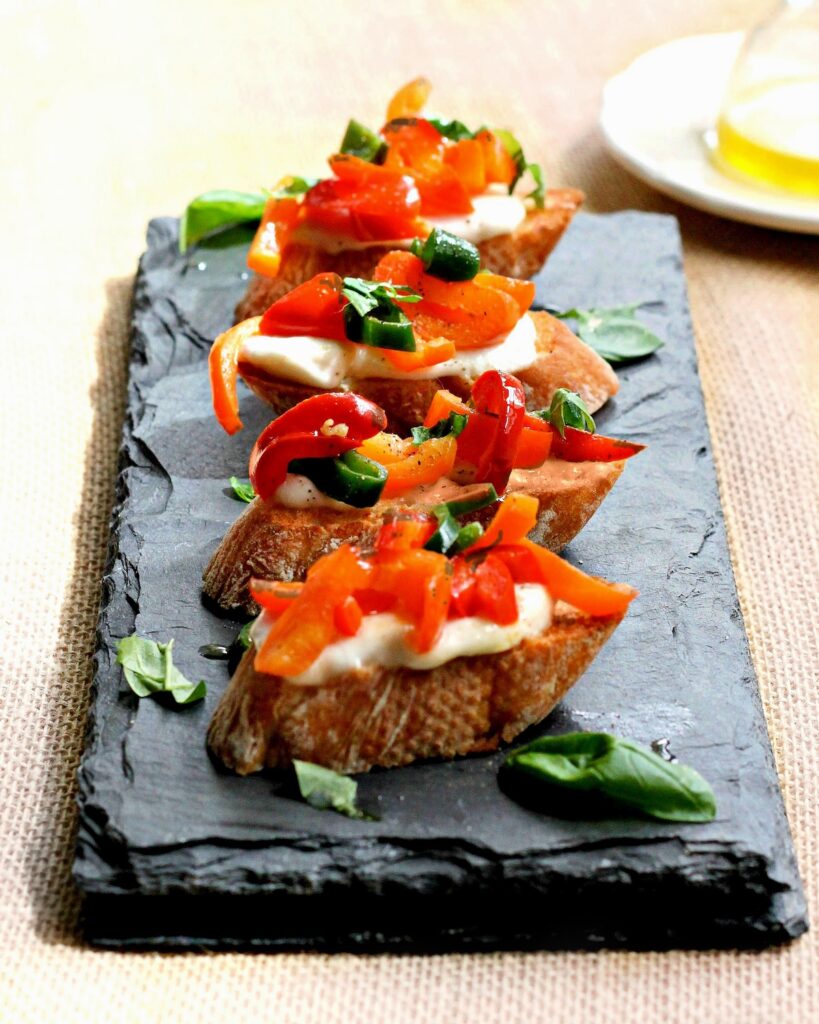 Pepper crostini on black plate