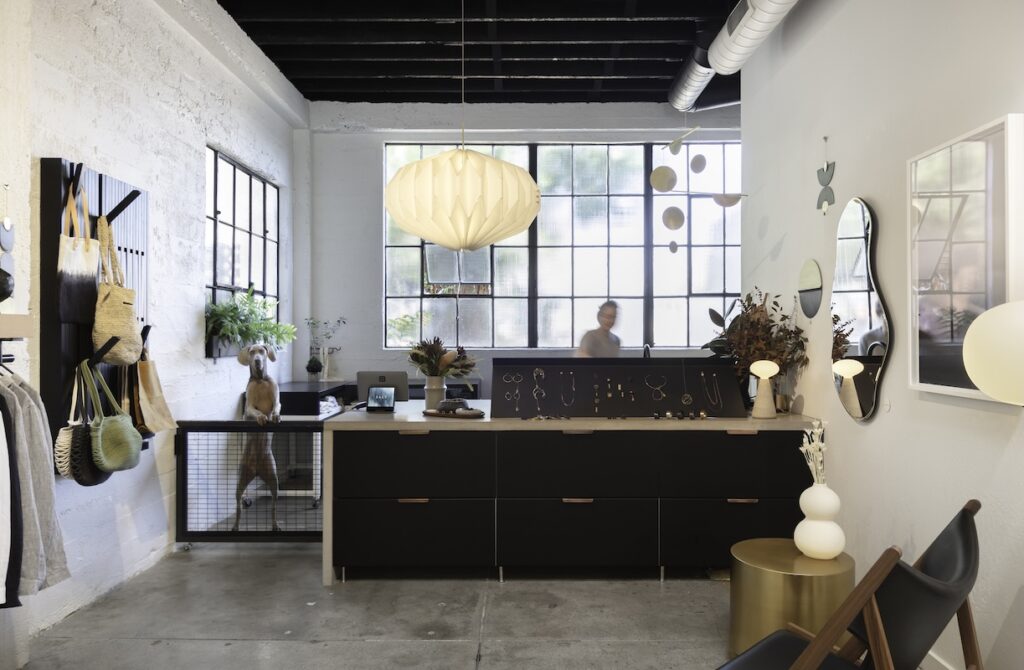A store's front desk area with dark wood and abstract shaped decor.