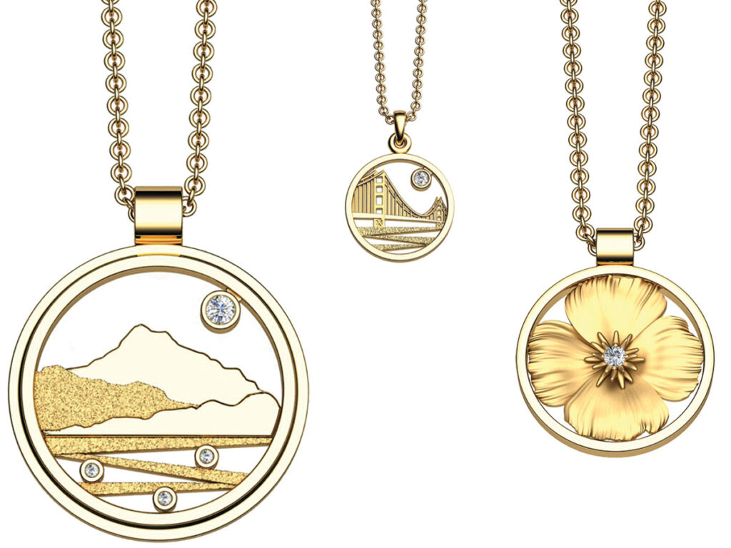 Three gold pendants featuring intricate designs of a flower and a mountain scene.