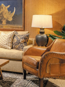 A cozy living room featuring a couch, coffee table, lamp, and a decorative rug.