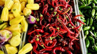 yellow, red and green peppers at a farmers market