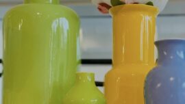 A set of colorful vases including green, yellow and purple.