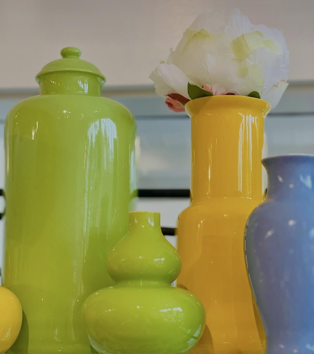 A set of colorful vases including green, yellow and purple.
