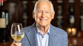 Larry Mindel with glass of wine