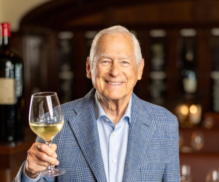 Larry Mindel with glass of wine