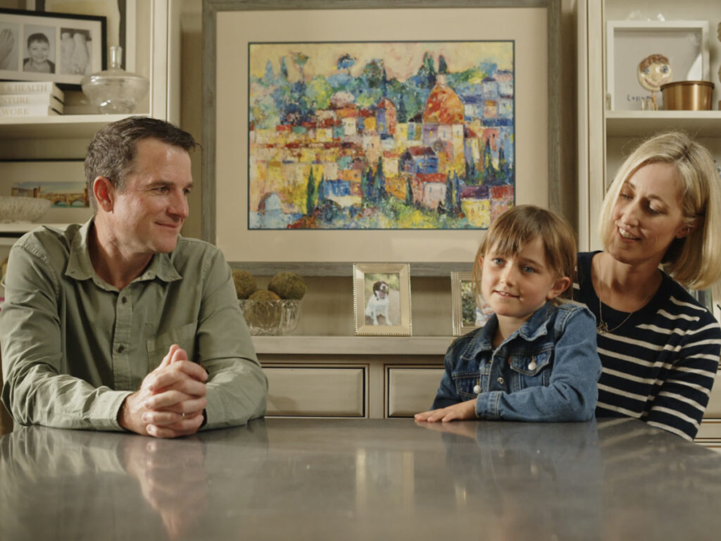 Mike, Courtney, and Kelsey Grady at a table during an interview