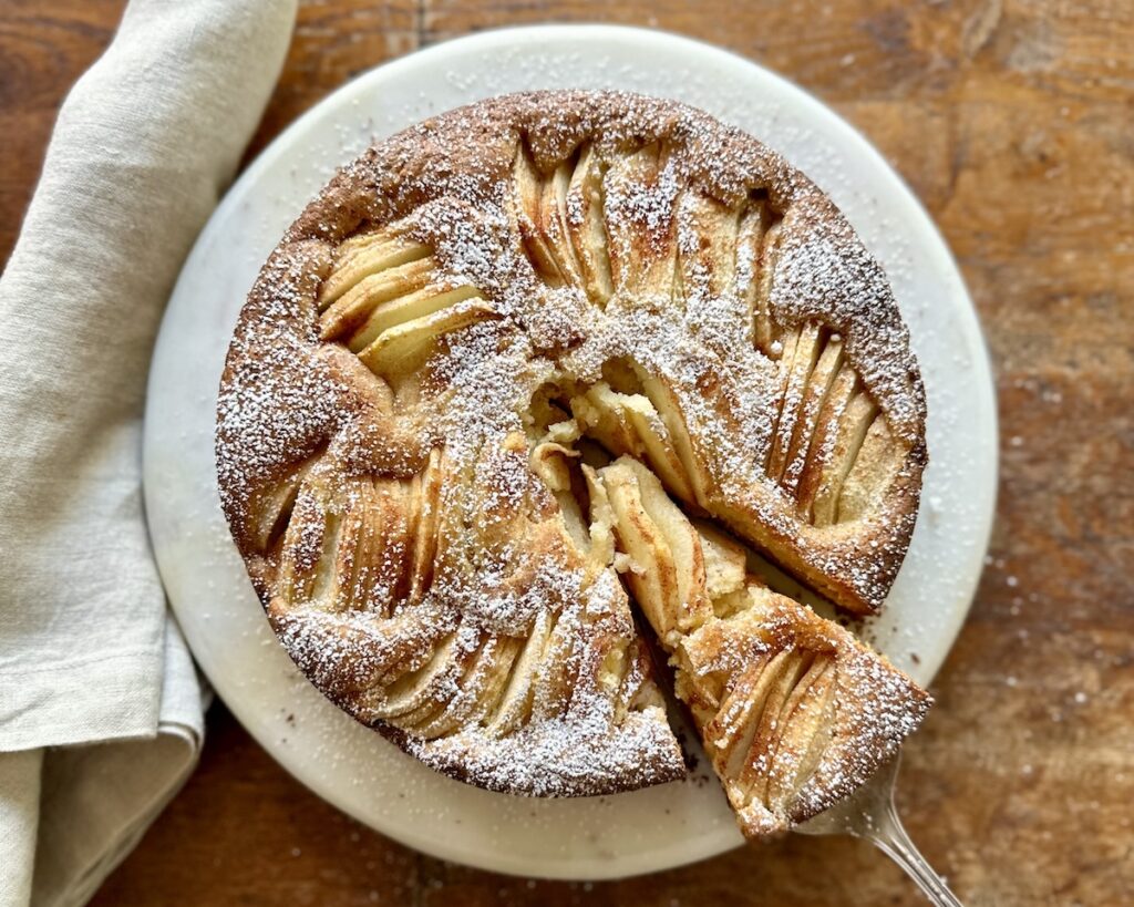 Sunken Pear Cake on round plate with pie spoon