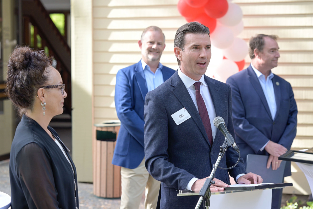 Community Action Marin leaders and guests smile as they cut a red ribbon together, marking the official opening of the agency’s new Novato campus during the Step Up Marin celebration.