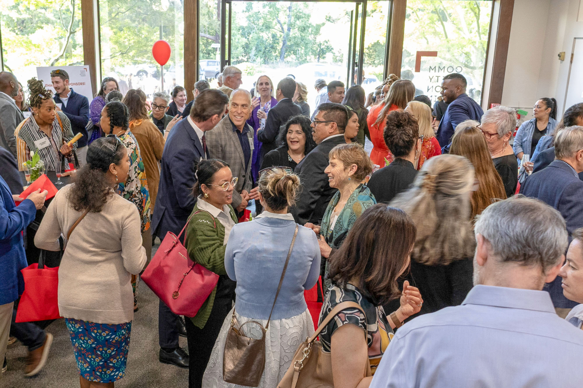 Guests mingle and converse inside the new Community Action Marin Novato campus lobby during the reception, creating a lively and welcoming atmosphere.