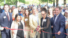 Community Action Marin CEO Chandra Alexandre delivers remarks at the podium, joined by Marin County Supervisor Eric Lucan, Assemblymember Damon Connolly, and Novato Mayor Tim O’Connor during the ribbon-cutting ceremony under red and white balloons.