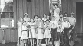 Historic photo of West Marin (Tomales) 4-H Club members with brooms and shovels after cleaning a railroad office, circa 1920s.