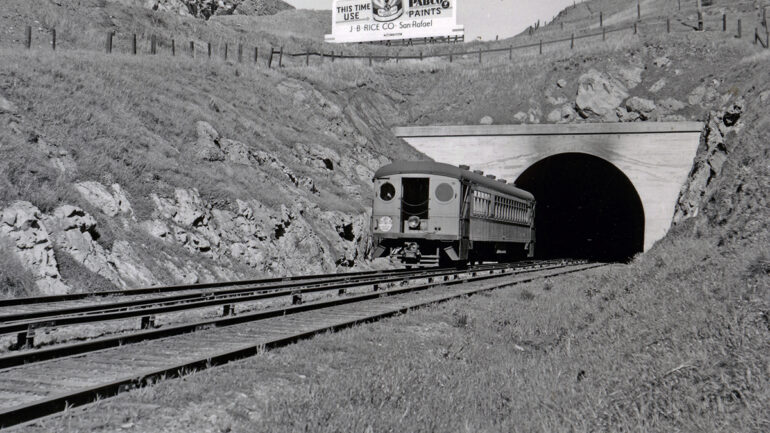 Historic photo of an electric powered interurban railcar entering the Cal Park Tunnel