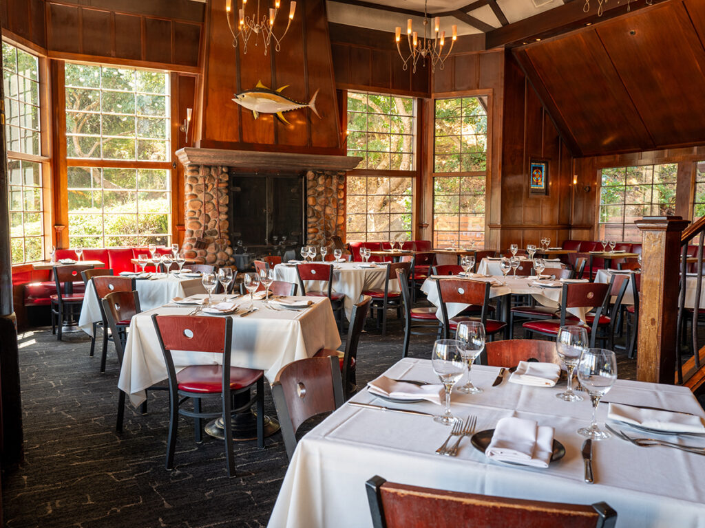 A spacious restaurant dining room filled with tables and chairs, showcasing a welcoming atmosphere for guests.