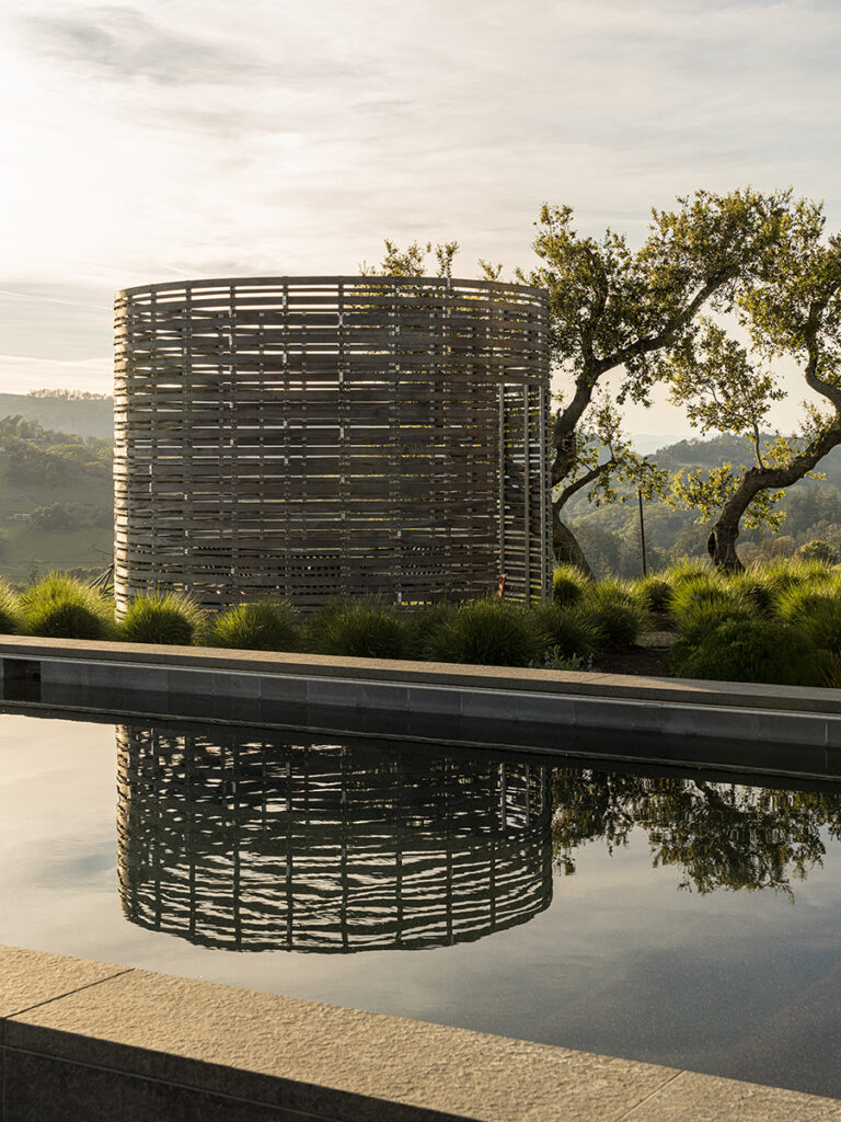 A 13-foot-tall silo-inspired structure softens the hard edges of the architecture as well as housing one of three fire pits on the property.