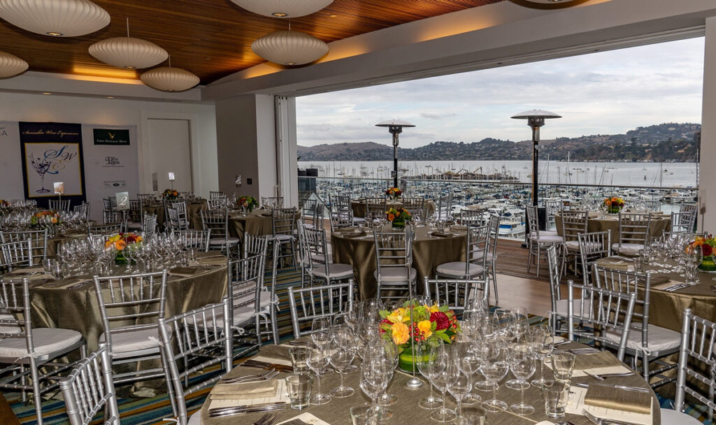 A large room featuring several tables and chairs, suitable for events or group activities.