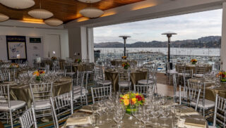 A large room featuring several tables and chairs, suitable for events or group activities.