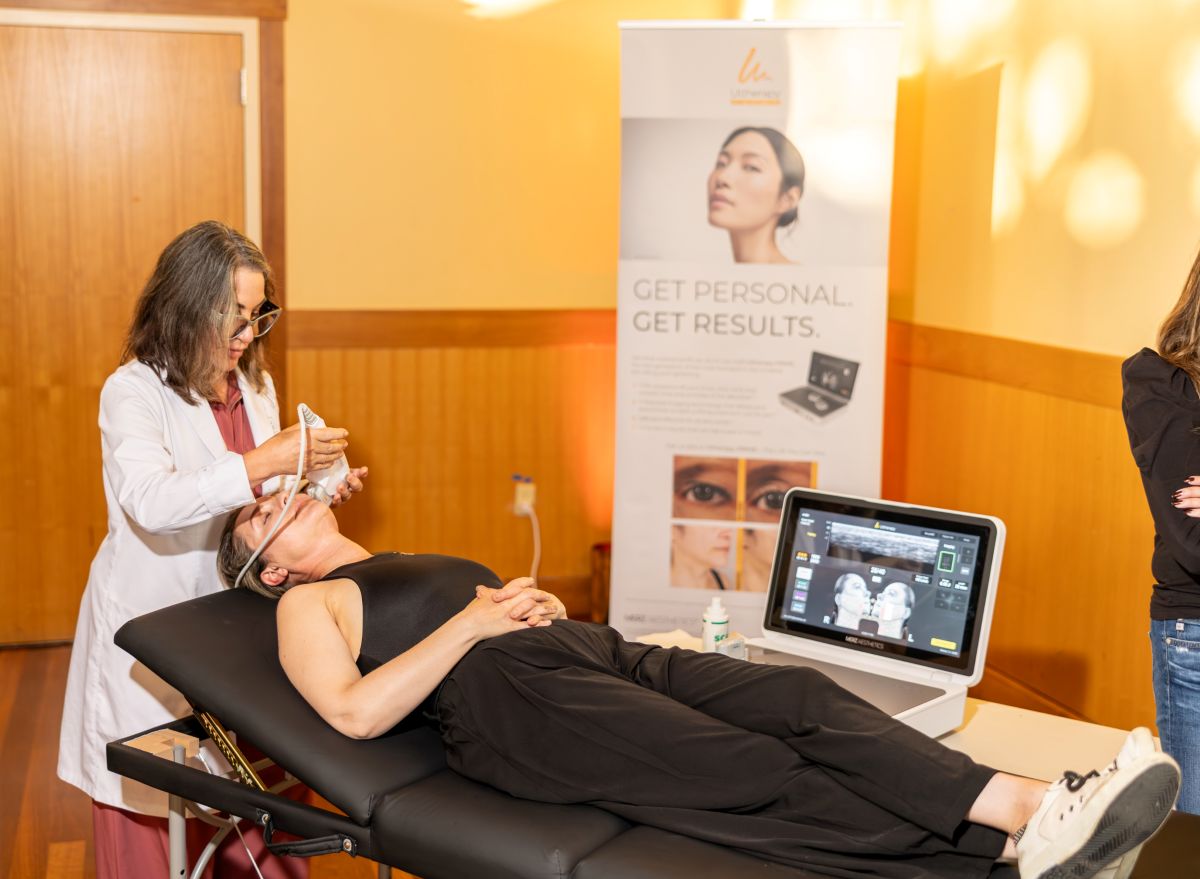 Skincare professional performing treatment on guest.