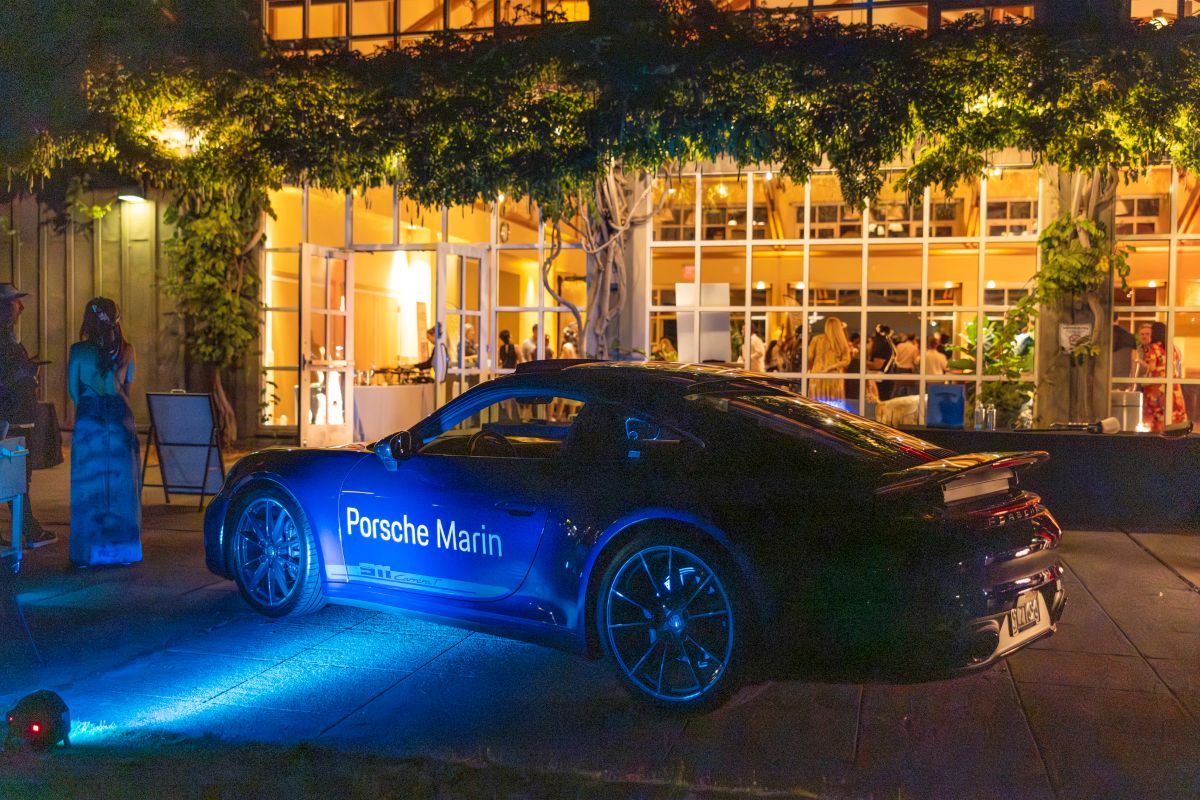 Porsche Marin car on display under evening lights.