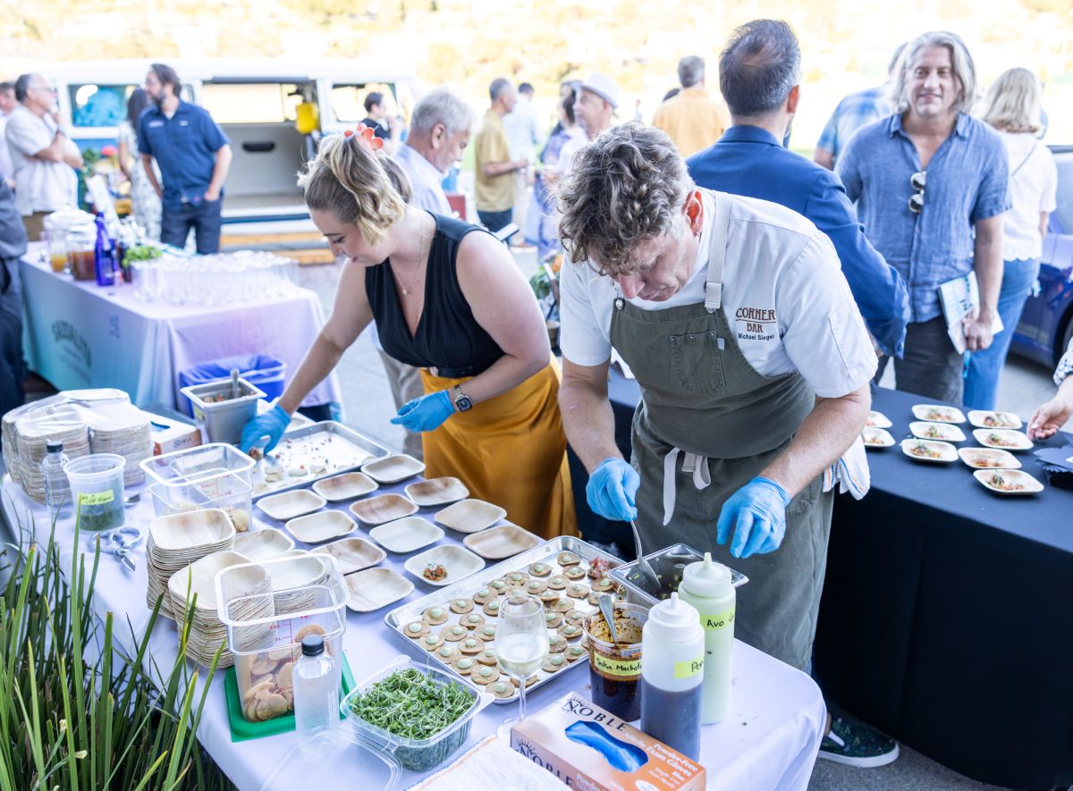 Chef and assistant plating small bites for guests.