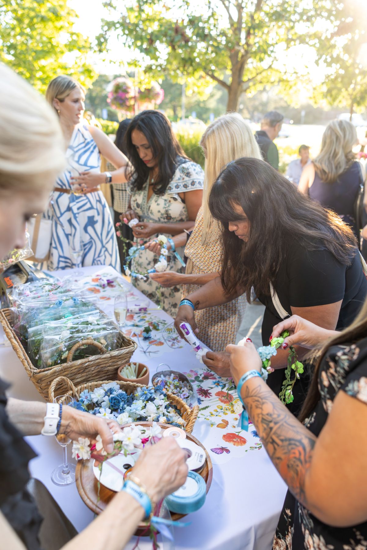 Guests making floral crowns at the craft table.