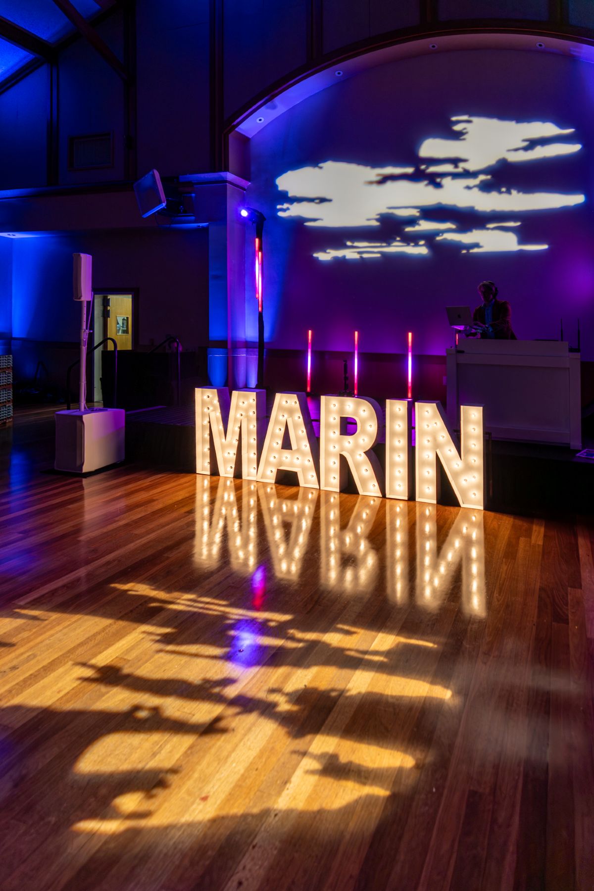 Illuminated “MARIN” letters with colorful lights and cloud projection.