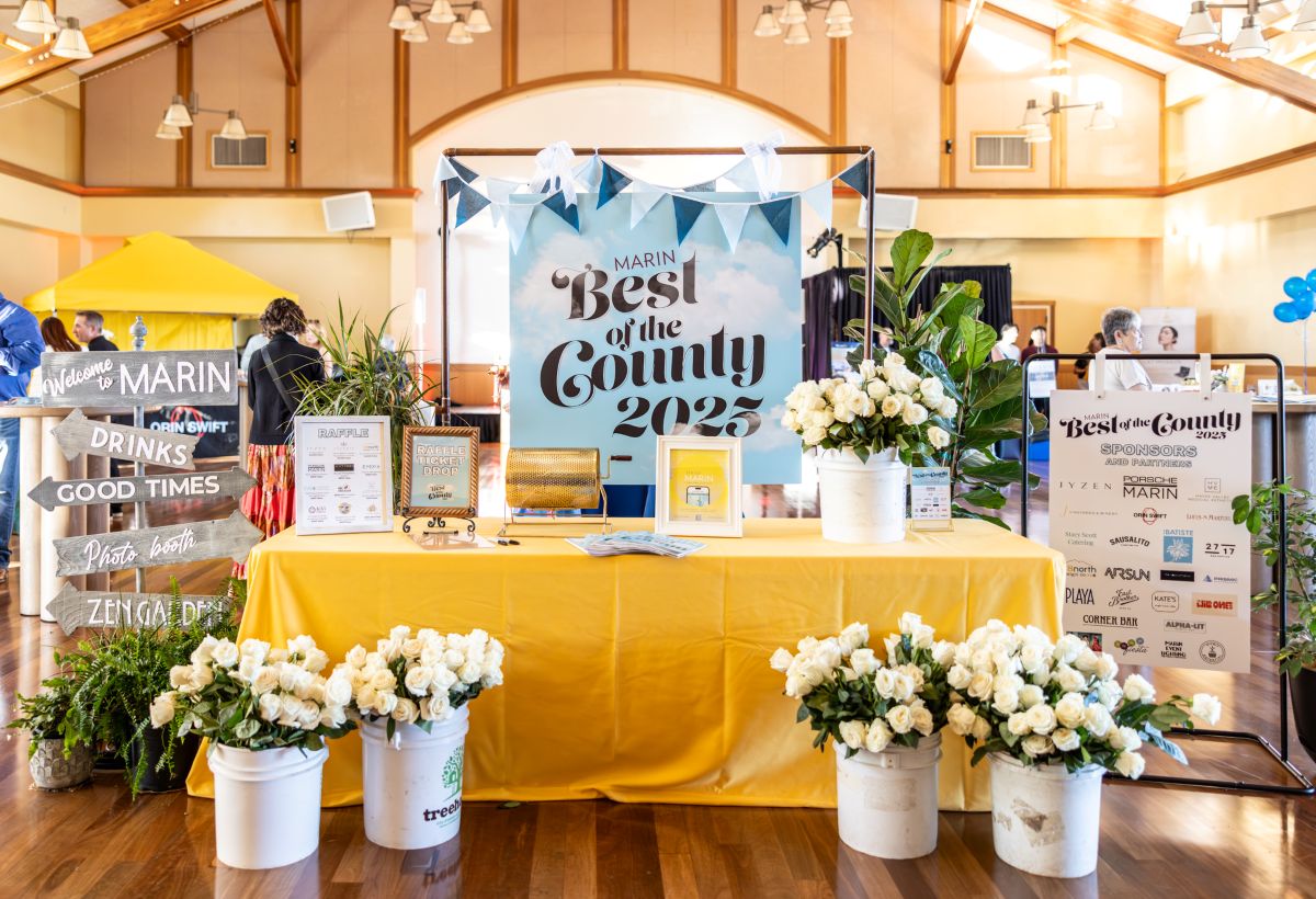 Decorated raffle and sponsor table with flowers and signage.