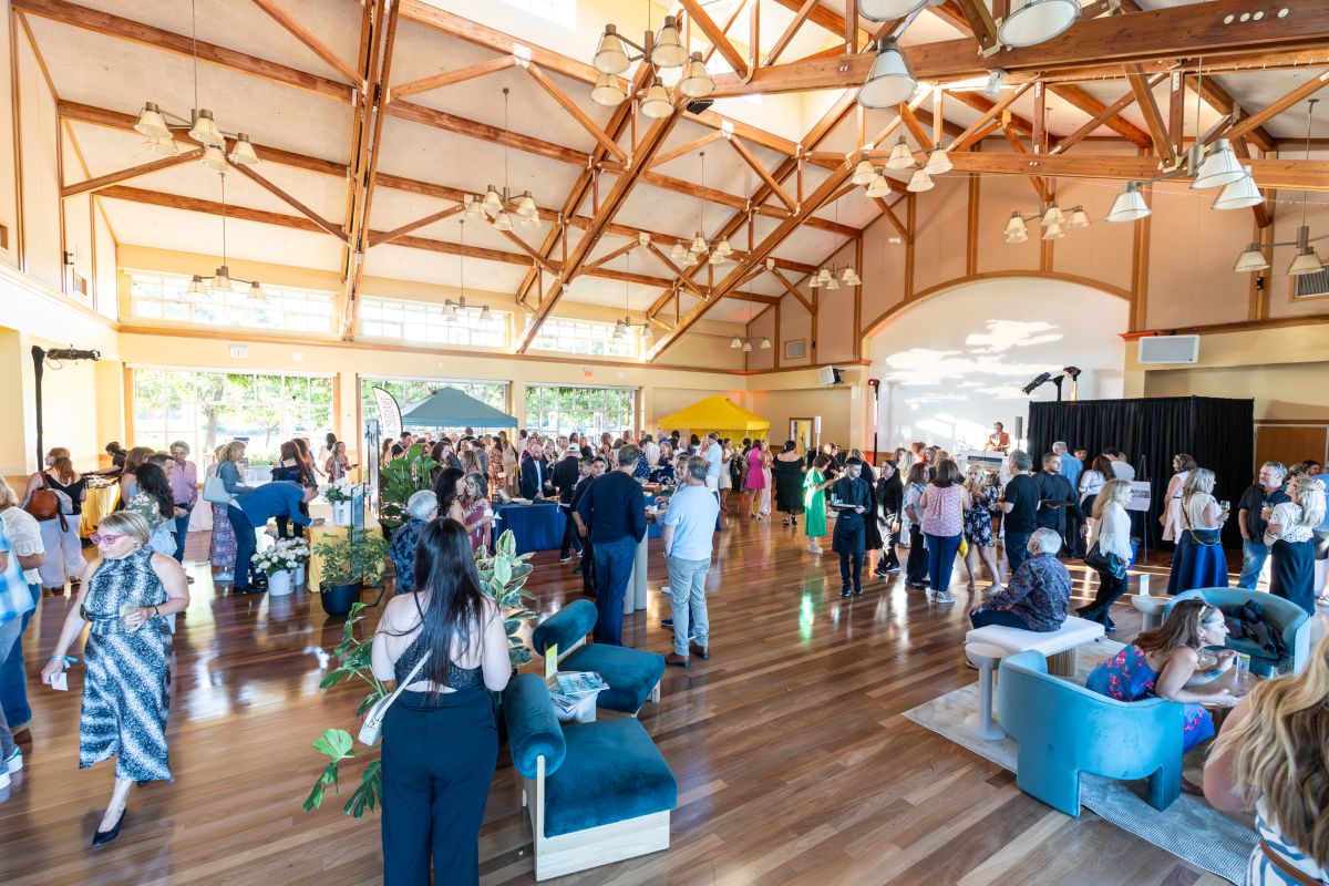 Large indoor crowd mingling in the main event hall.