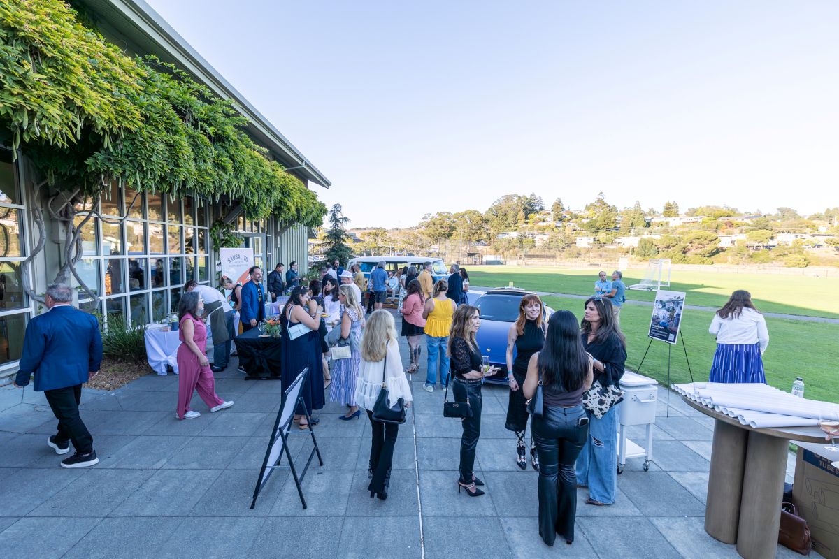 Guests mingling outside along the venue patio.