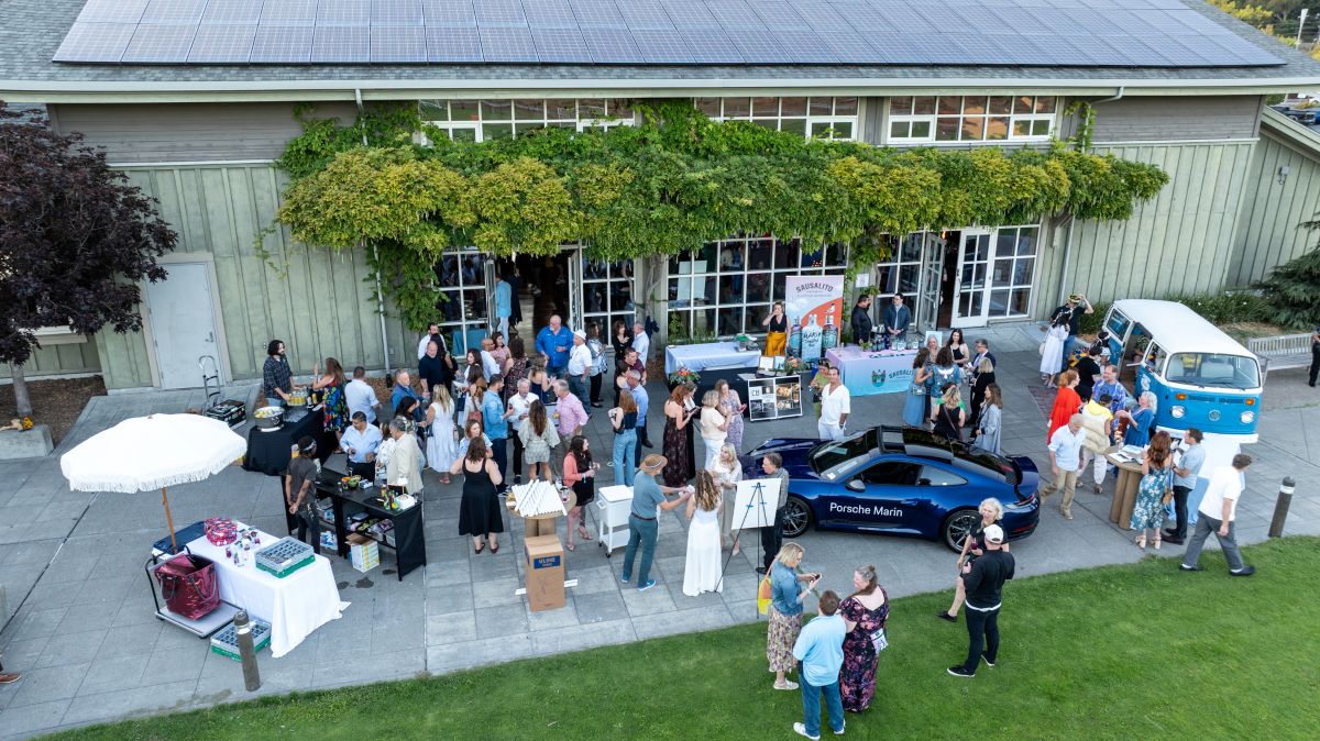 Aerial shot of guests gathered outside with sponsor booths.