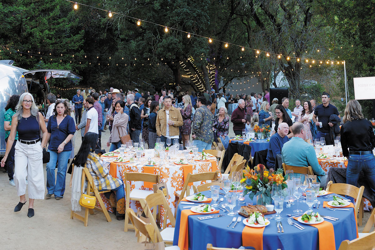 A group of people gathered around tables, chatting and drinking