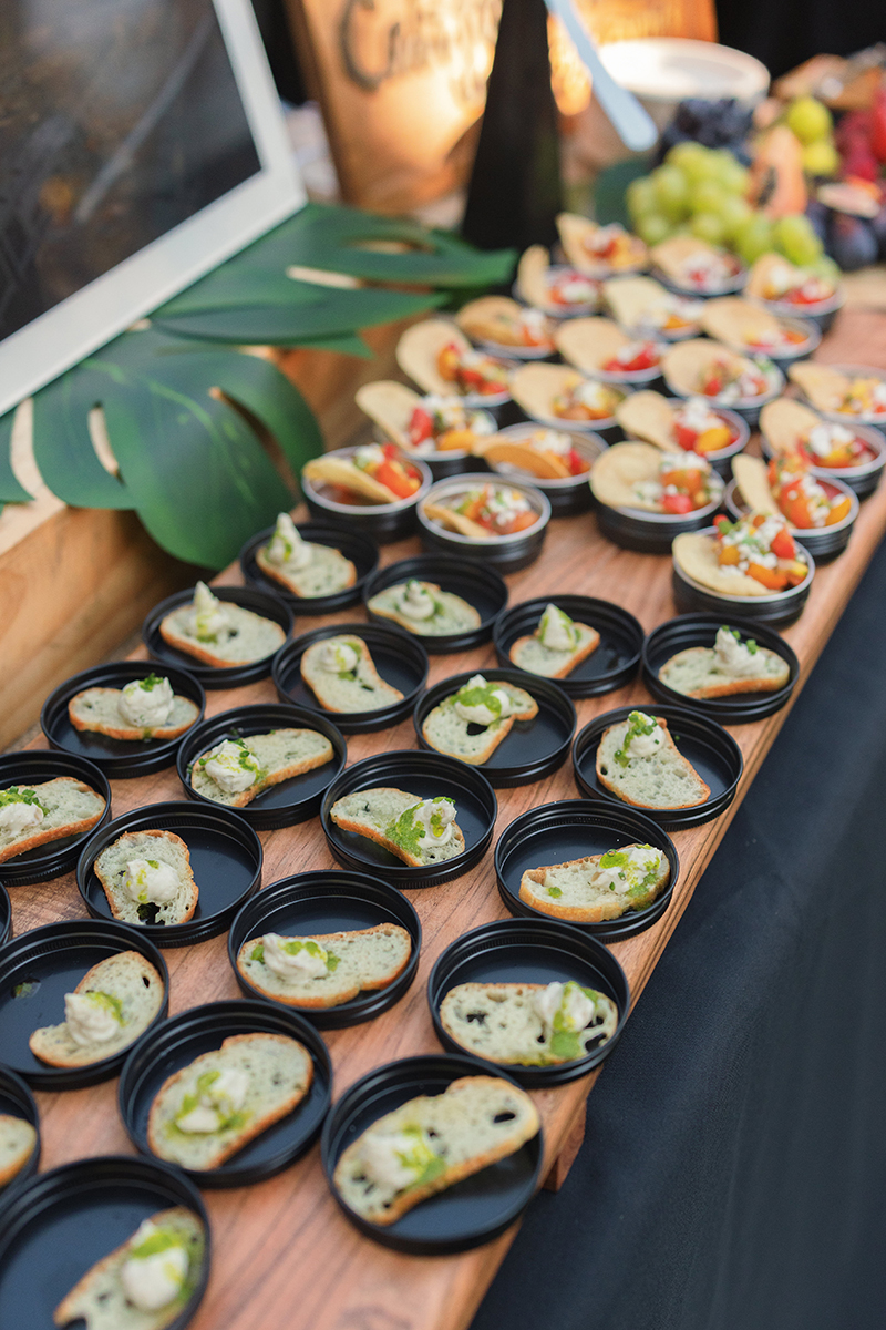 A table filled with various plates of colorful food, showcasing a diverse array of dishes and culinary styles.