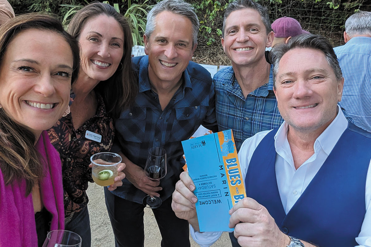 A group of people smiling and posing together, celebrating a special occasion.