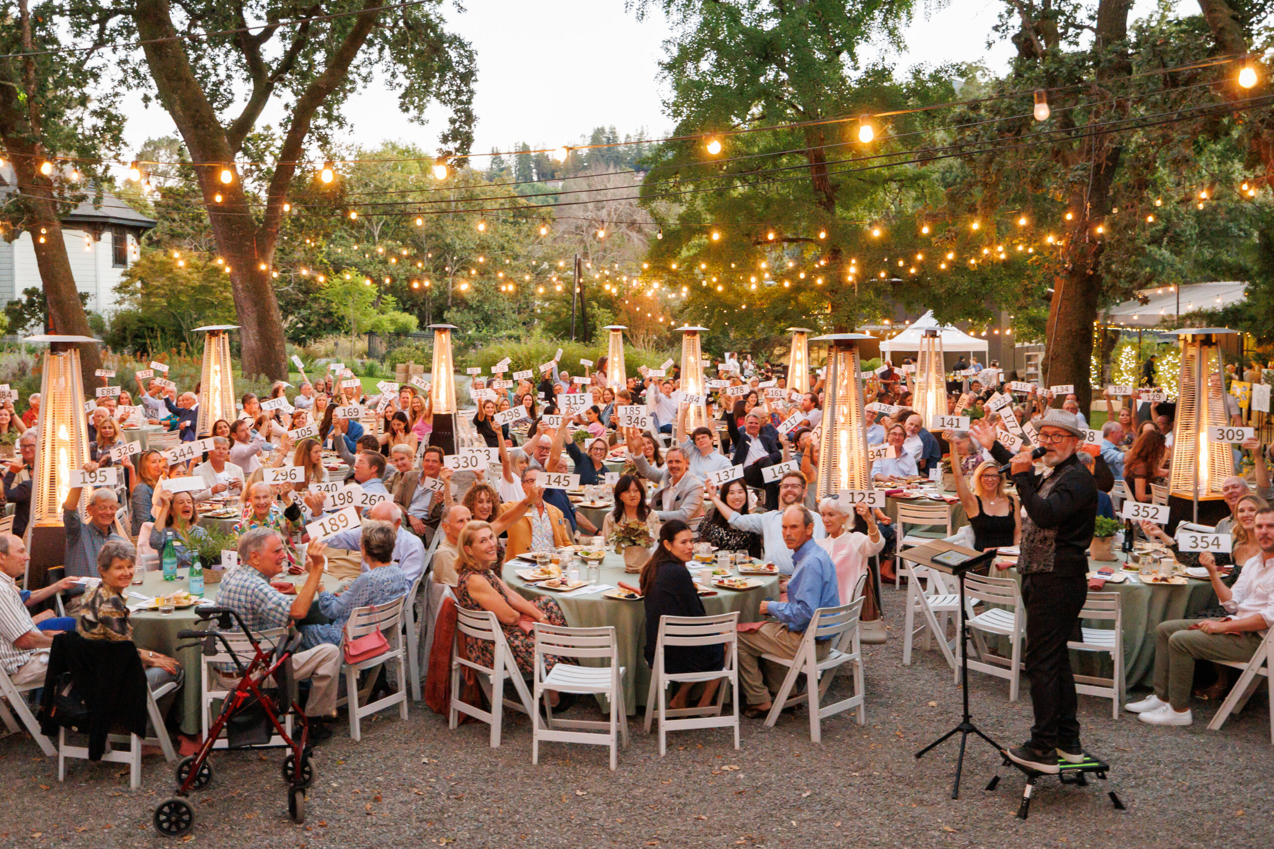 Guests raise bidding paddles at Marin Art and Garden Center's outdoor venue.